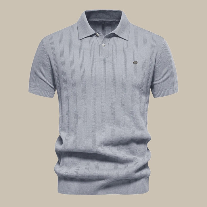 Grey men's knit polo shirt. Breathable short sleeve top for classic smart-casual wear & modern comfort.