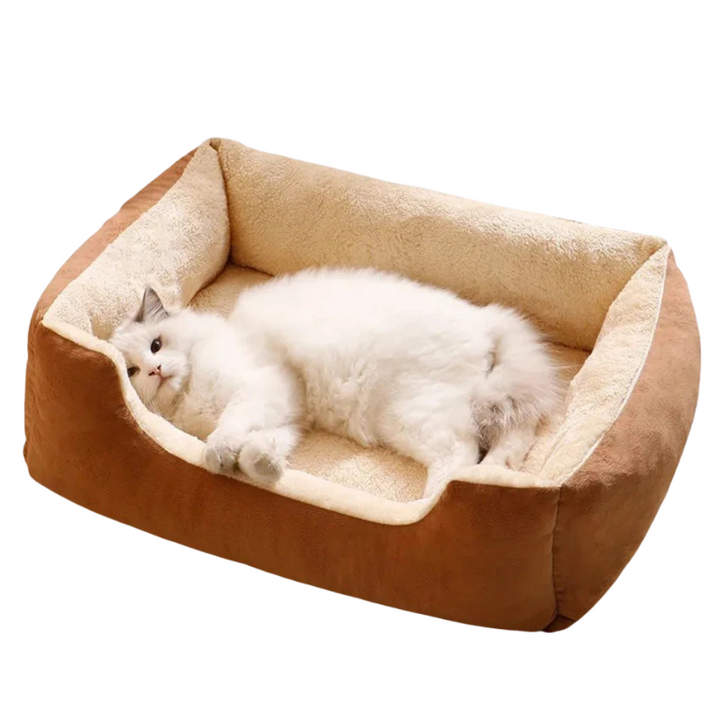 Comfortable pink plush pet bed for cats & small dogs, a cozy cloud-like pet furniture piece.