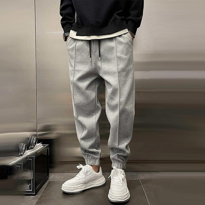 Men's relaxed fit casual trousers, neutral color, perfect for comfortable everyday wear.