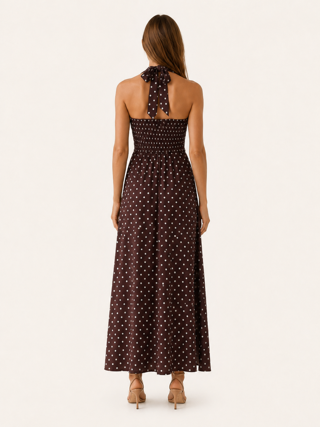 Chic women's polka dot halter neck maxi dress with smocked waist. Ideal for elegant evening wear & summer fashion.