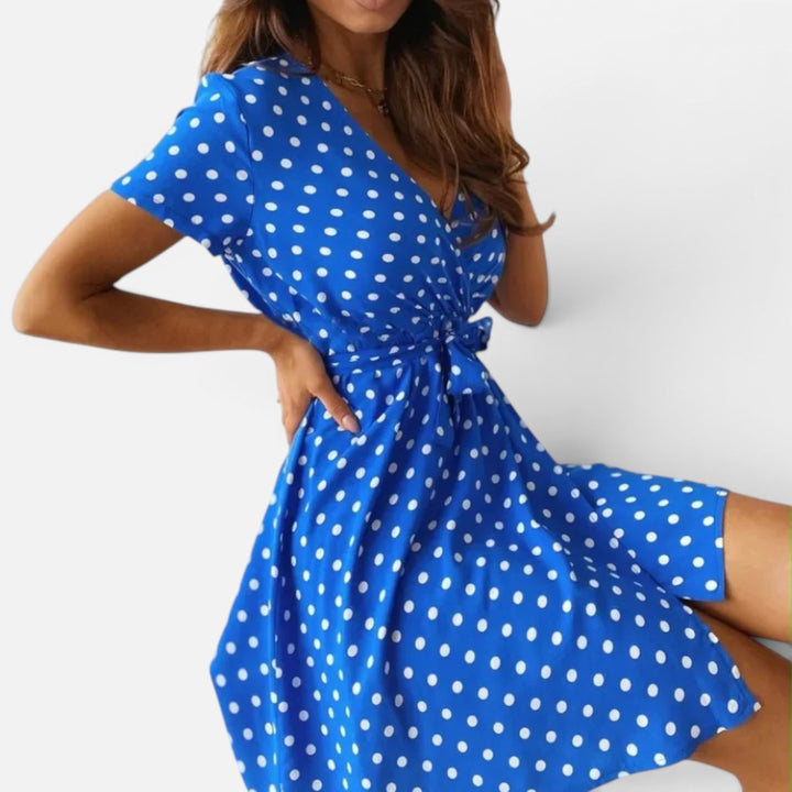 Women's versatile polka dot wrap mini dress with short sleeves. Elegant V-neck, flattering fit for casual and formal wear.