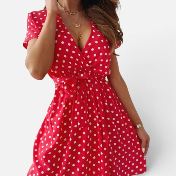 Elegant women's polka dot wrap mini dress, short sleeve V-neck. Flattering fit, perfect for casual or smart-casual wear.