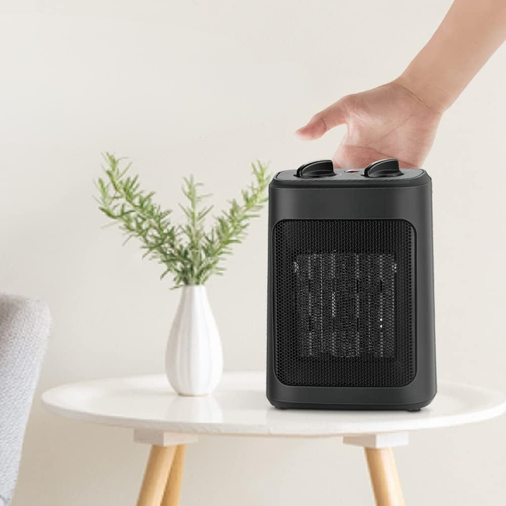 Compact indoor space heater with adjustable heat settings & fan mode for personalized room warming. Safety features.