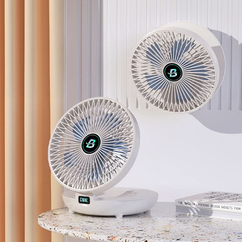 Person holding a mini portable USB rechargeable handheld fan for instant cooling.