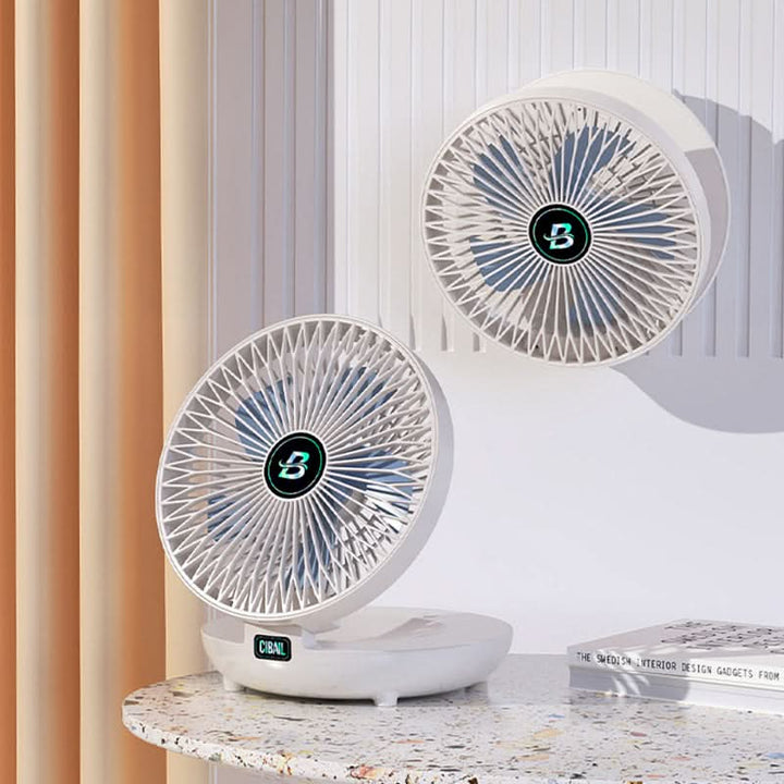 Person holding a mini portable USB rechargeable handheld fan for instant cooling.
