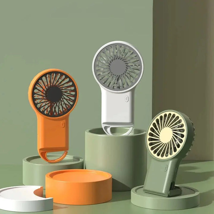 Orange USB personal cooling fan, portable for travel and desktop use. Offers strong, quiet air circulation.