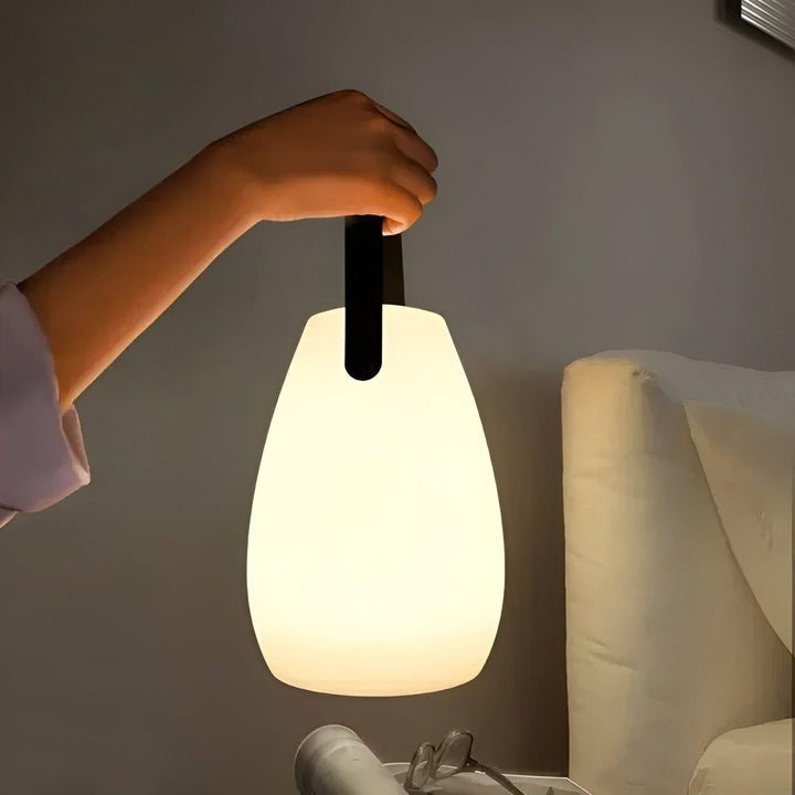 Portable waterproof cordless lamp with remote control, sleek modern design, suitable for indoor and outdoor lighting.