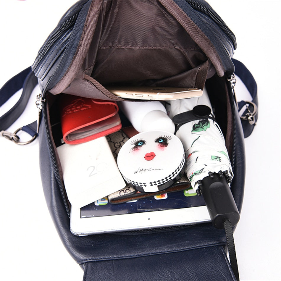 Top view of a women's luxury water-resistant leather travel backpack. Ample storage & easy access.
