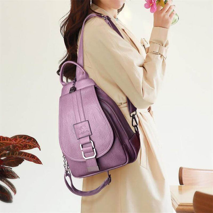 Brown women's premium water-resistant leather backpack. Elegant fashion shoulder bag for everyday.