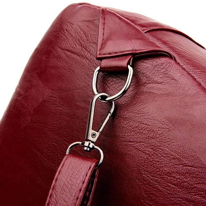 Close-up of the anti-theft zipper on a premium women's water-resistant leather backpack. Secure design.