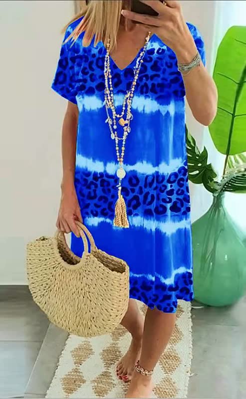 Comfortable women's shift dress featuring a vibrant bold print and stylish V-neck. Ideal for summer casual chic.