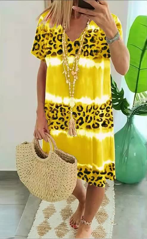Stylish women's V-neck shift dress with a unique bold print. Comfortable, short sleeve, and versatile casual wear.