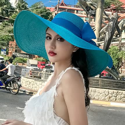 Braided straw wide brim women's sun hat with a charming bow, offering excellent sun coverage.