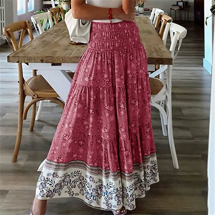 Vibrant women's bohemian tiered midi skirt with a flowing design & elastic waist, perfect for summer vacation fashion.