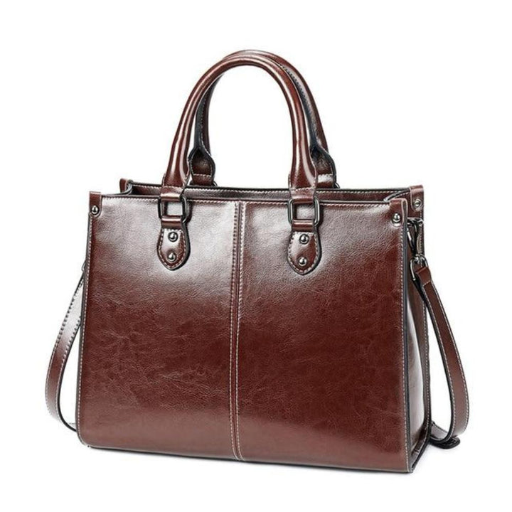 Premium women's leather tote handbag, elegant design with secure zipper closure, perfect as a stylish shoulder bag.