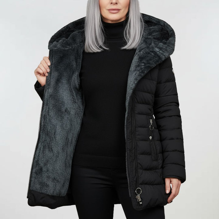 Close-up of durable, waterproof fabric on women's winter coat, designed for warmth and protection.