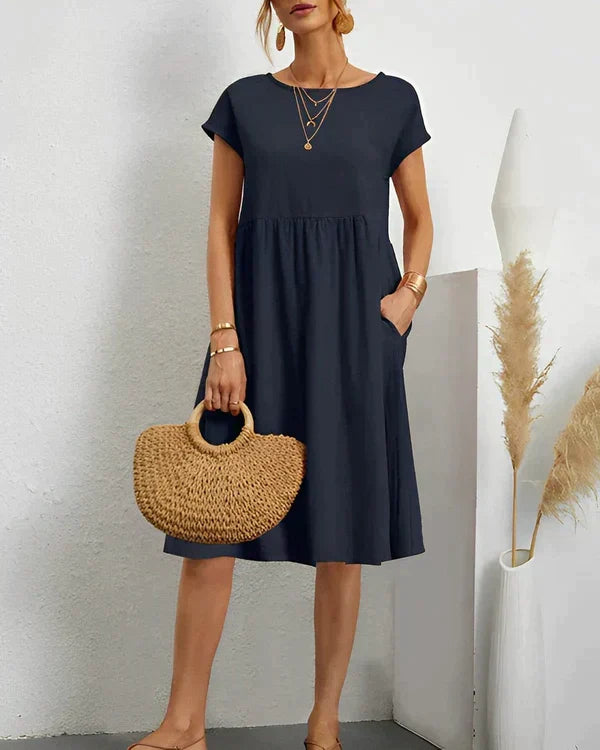 Women's comfortable round neck dress in a versatile midi length, ideal for both casual and formal occasions.