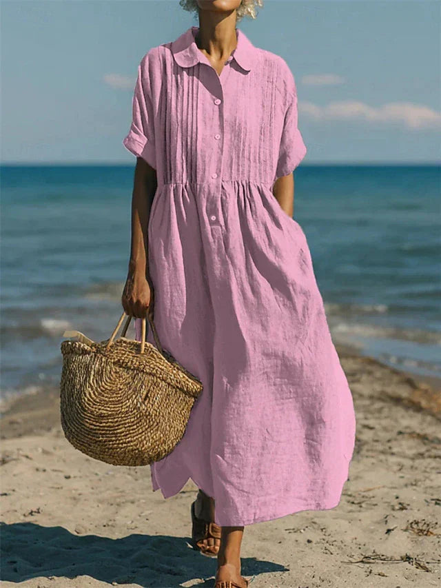 Flowy women's button-front maxi dress, designed with a relaxed fit and functional pockets for everyday style.