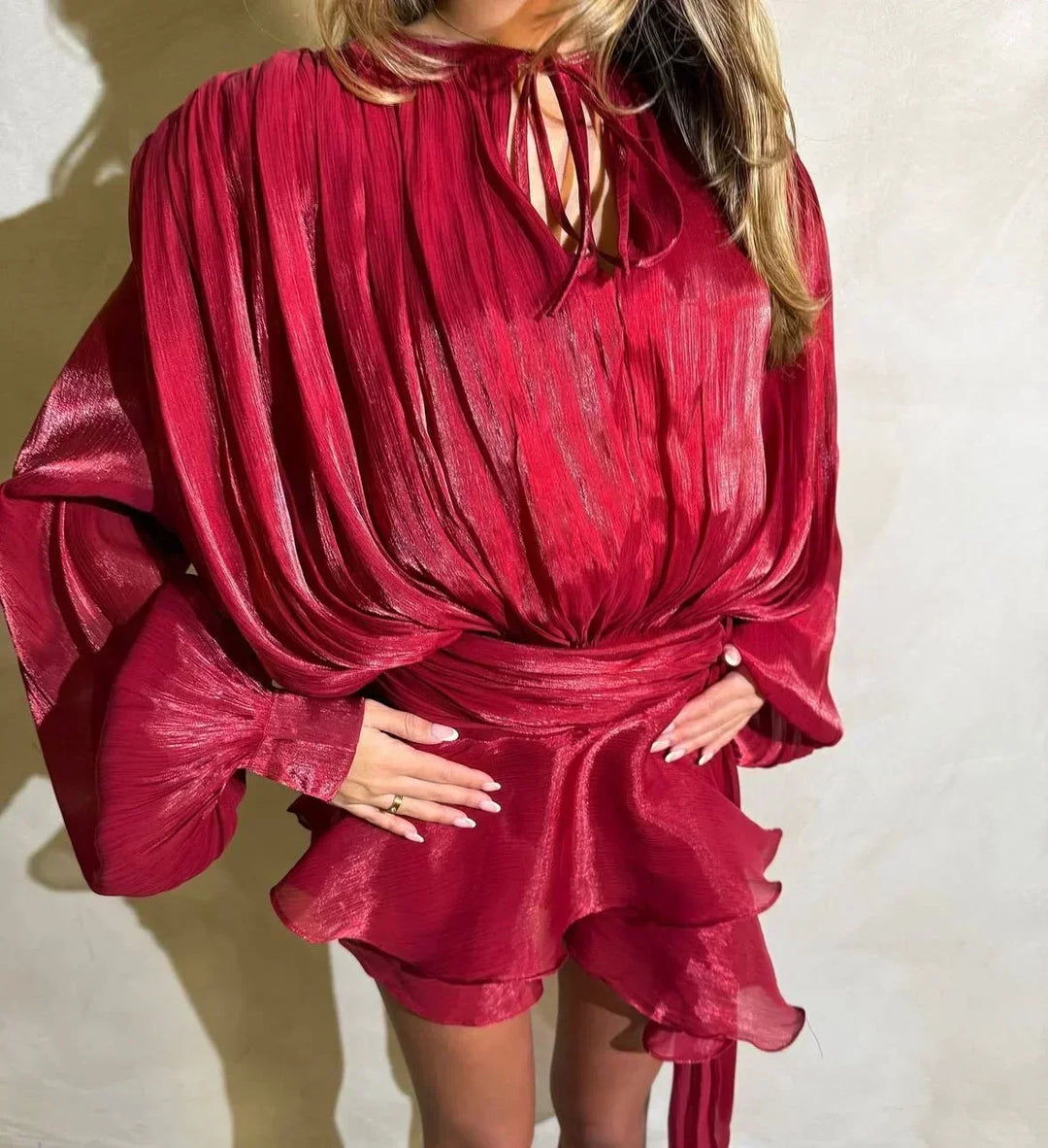 Sophisticated women's summer mini dress, featuring a pleated skirt, puff sleeves & a stylish tie-waist.