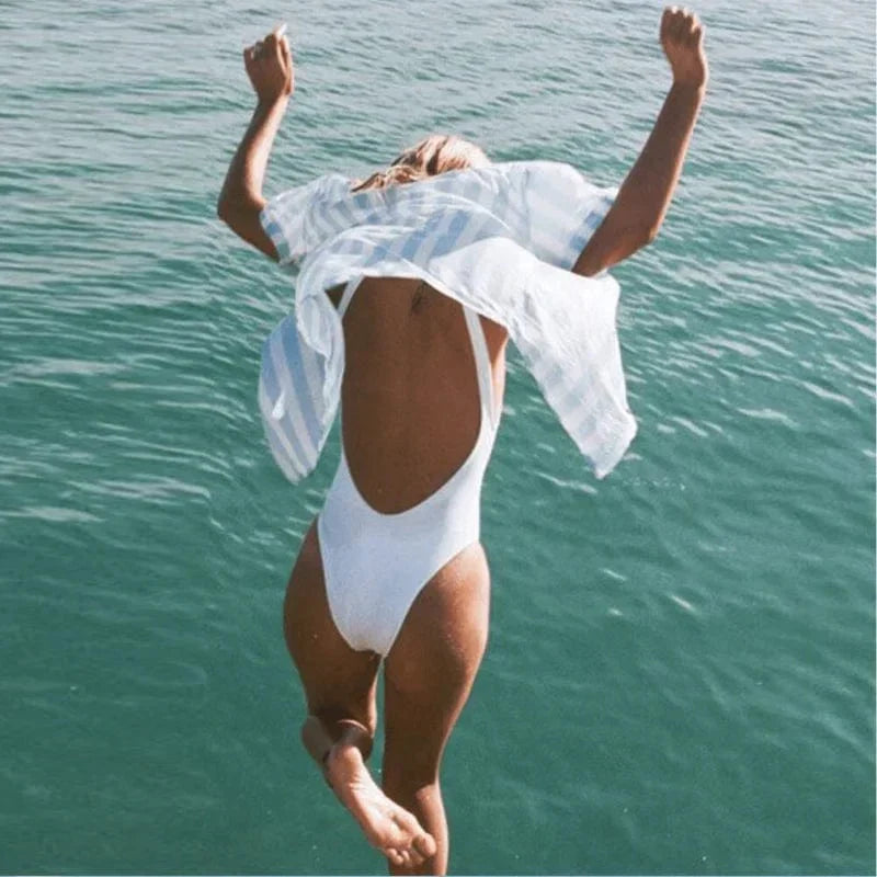Women's elegant one-piece swimsuit with backless design, ideal for summer beachwear.