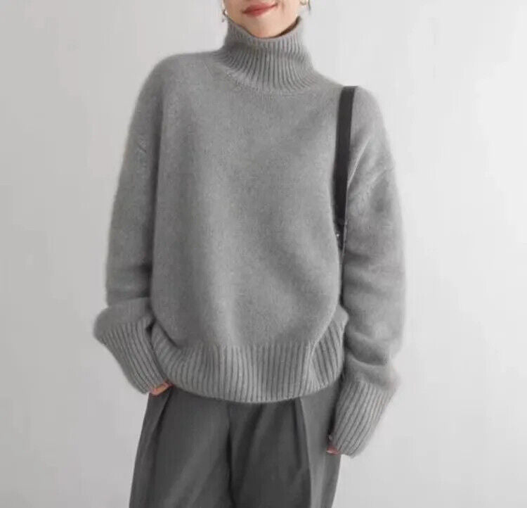 Cozy women's grey turtleneck sweater with a soft relaxed fit, perfect for elegant winter fashion pullover style.