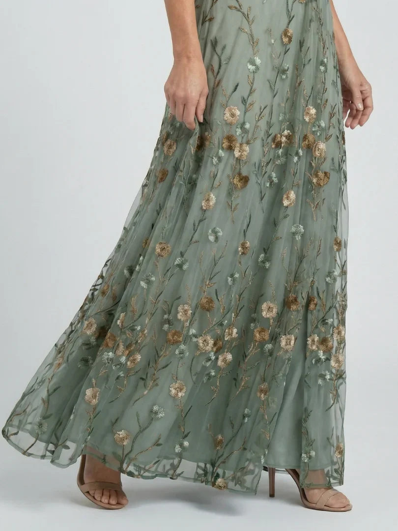 Women's floral embroidered wedding guest maxi dress. Elegant & flowy for summer garden parties.