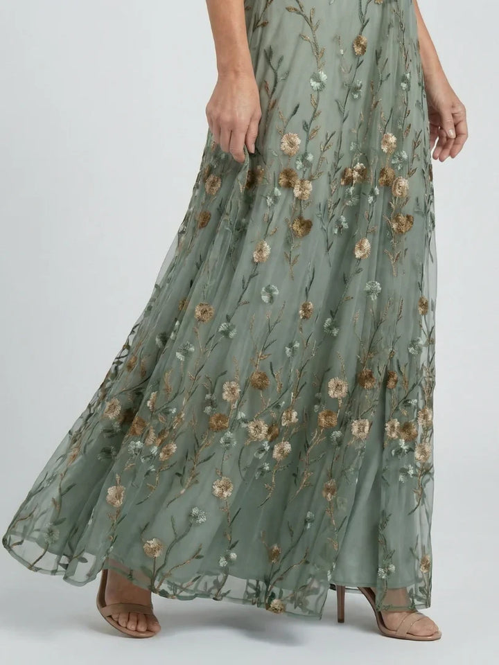 Women's floral embroidered wedding guest maxi dress. Elegant & flowy for summer garden parties.