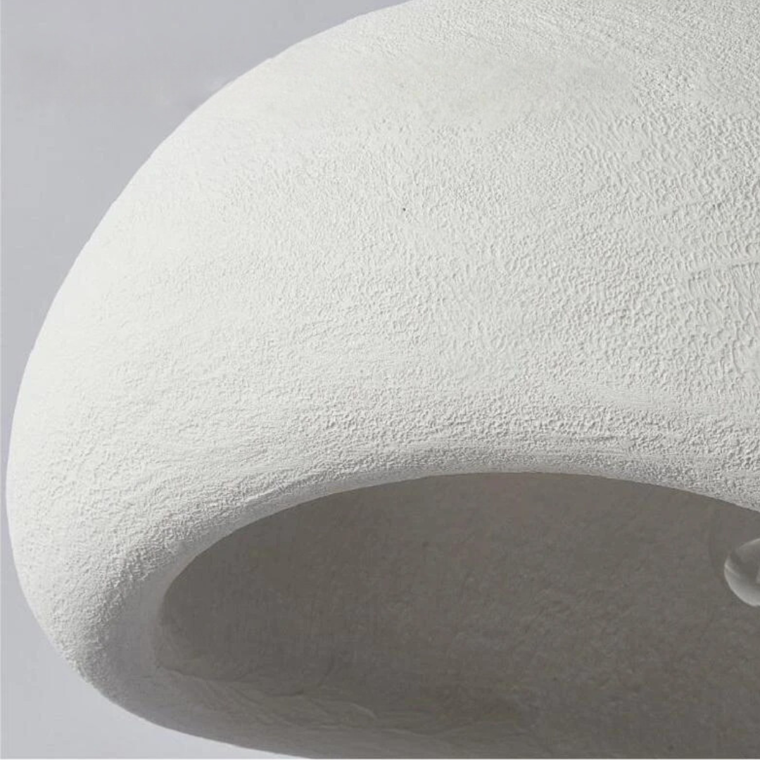 Contemporary sculpted dome pendant light, minimalist design, adjustable for modern home and interior lighting.