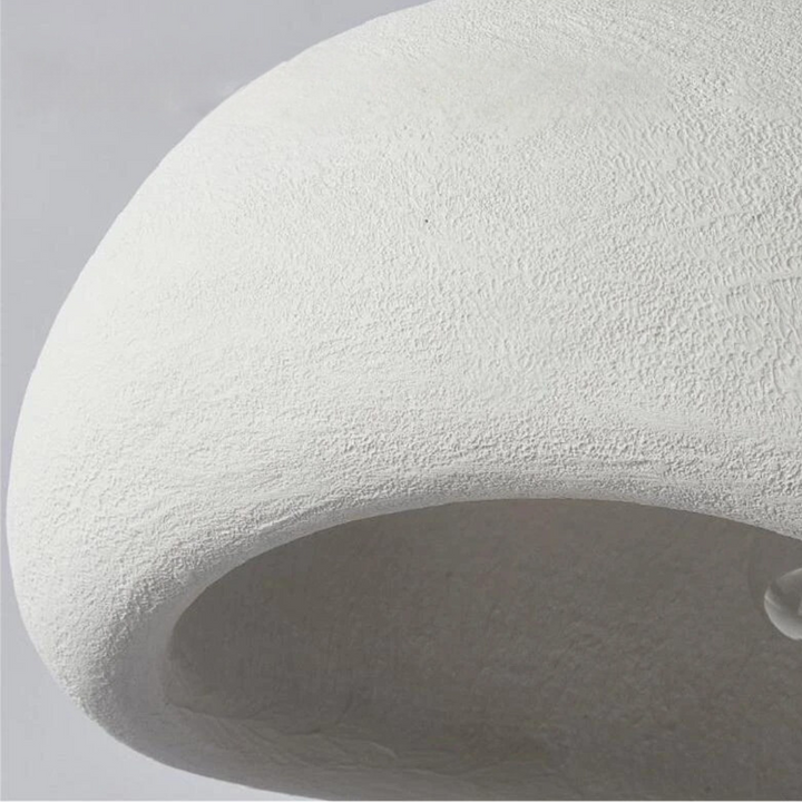 Contemporary sculpted dome pendant light, minimalist design, adjustable for modern home and interior lighting.