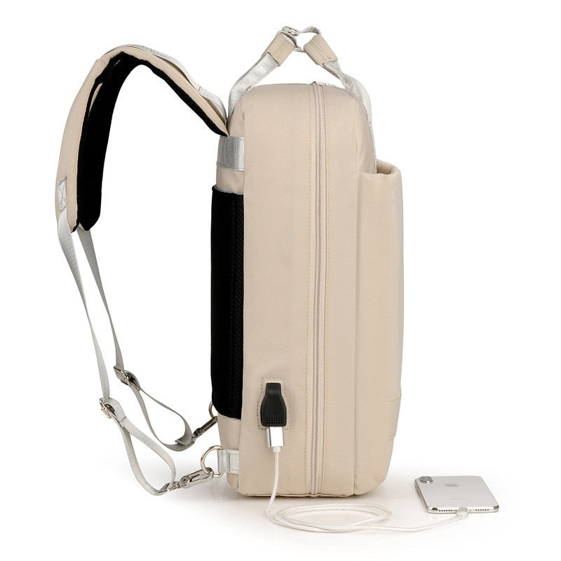 USB charging port on a unisex anti-theft backpack. Convenient power for devices while commuting or traveling securely.