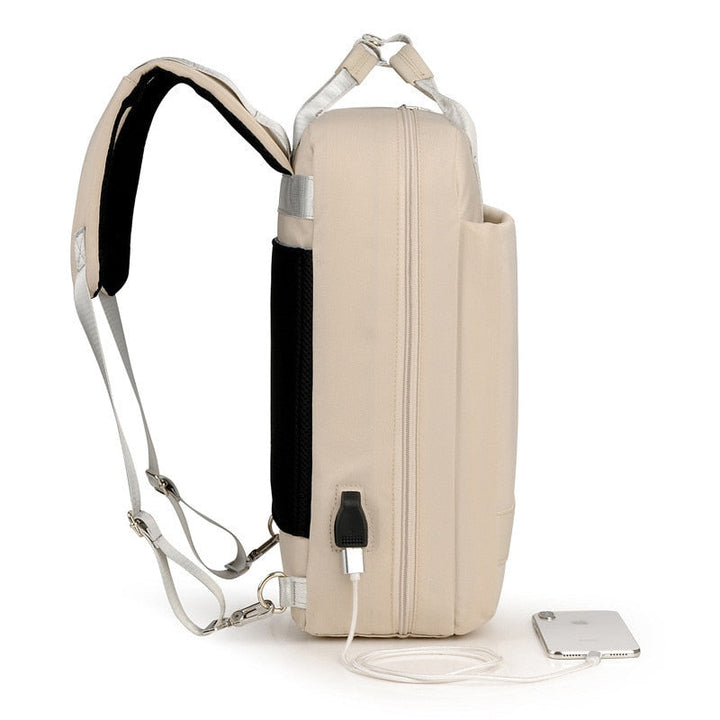 USB charging port on a unisex anti-theft backpack. Convenient power for devices while commuting or traveling securely.