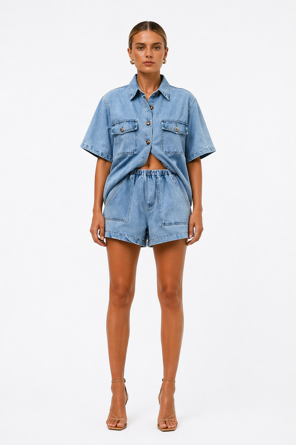 Women's casual denim summer outfit: a chic button shirt & high-waist shorts co-ord set, great for travel.