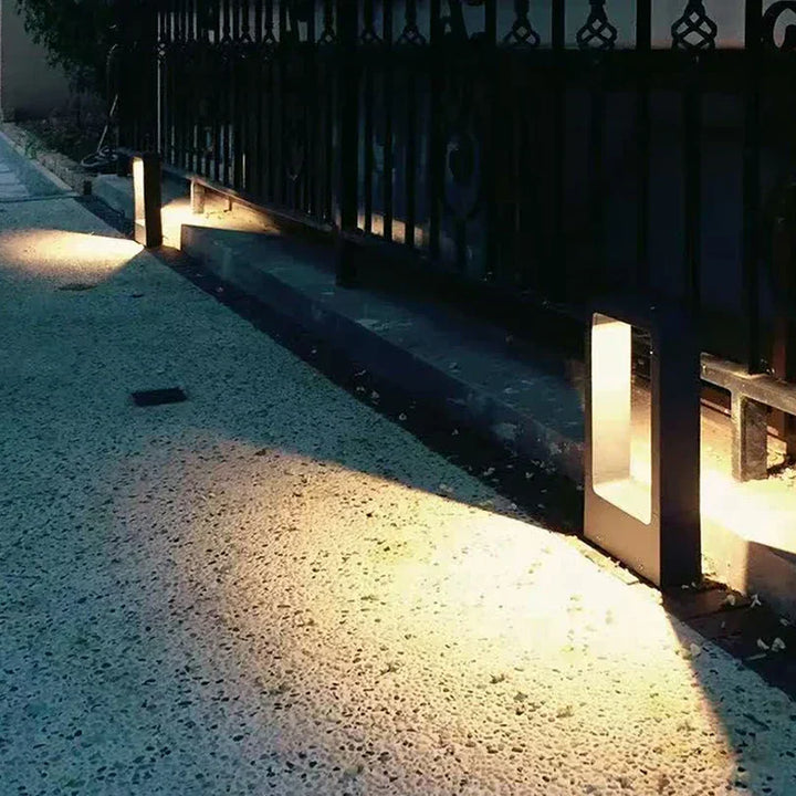 "Sleek aluminium outdoor garden light, weatherproof IP68 design, available in black or grey, enhances patios and pathways."