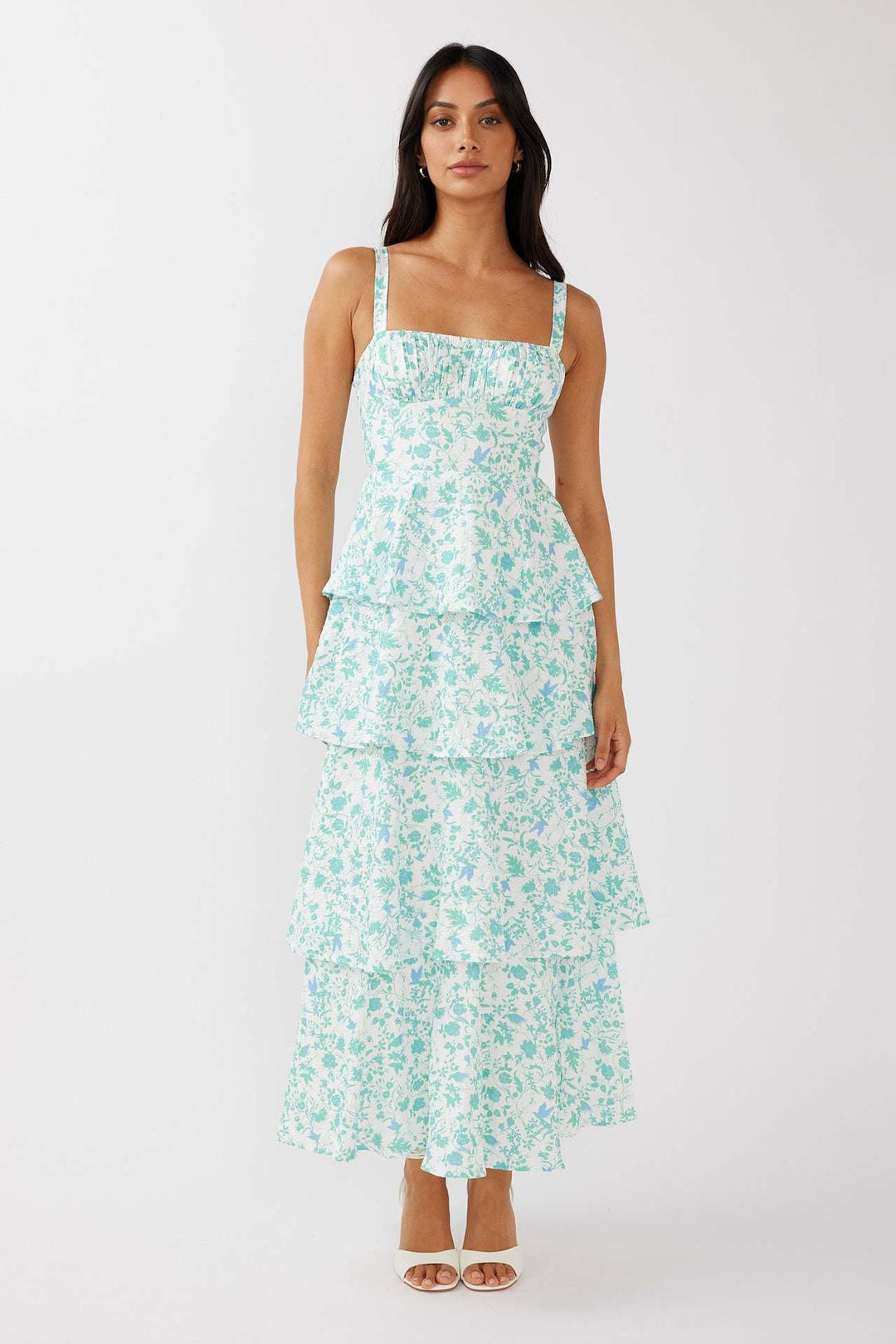 "Sleeveless floral midi dress with ruffled skirt, highlighting elegant slim-fit bodice in vibrant spring colors."