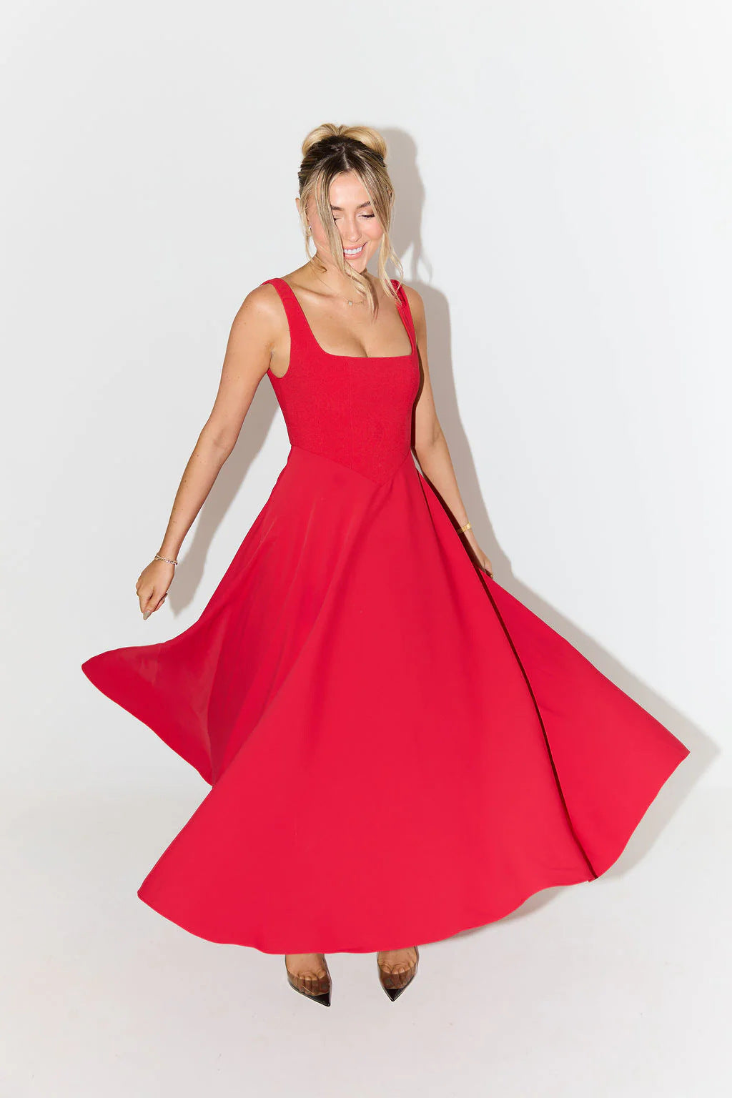 "Sleeveless satin midi dress with square neckline, fitted bodice; elegant women's fashion for special occasions."