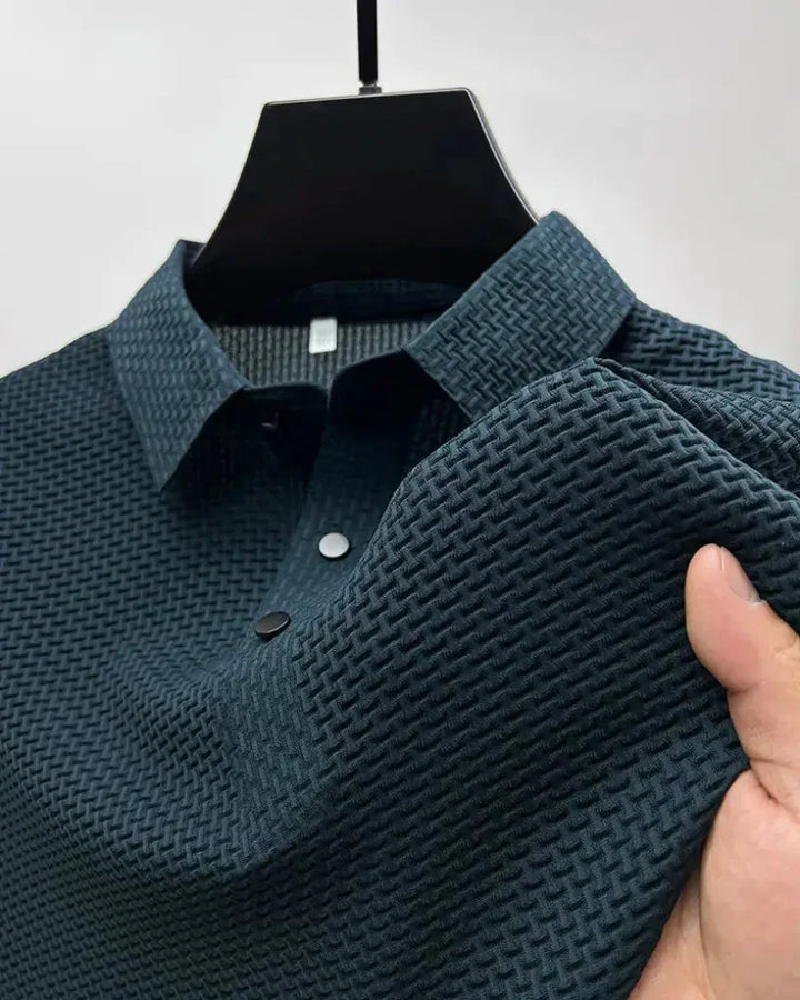 Man in a comfortable, stylish men's polo shirt. Short-sleeve top for elegant casual wear or office attire.