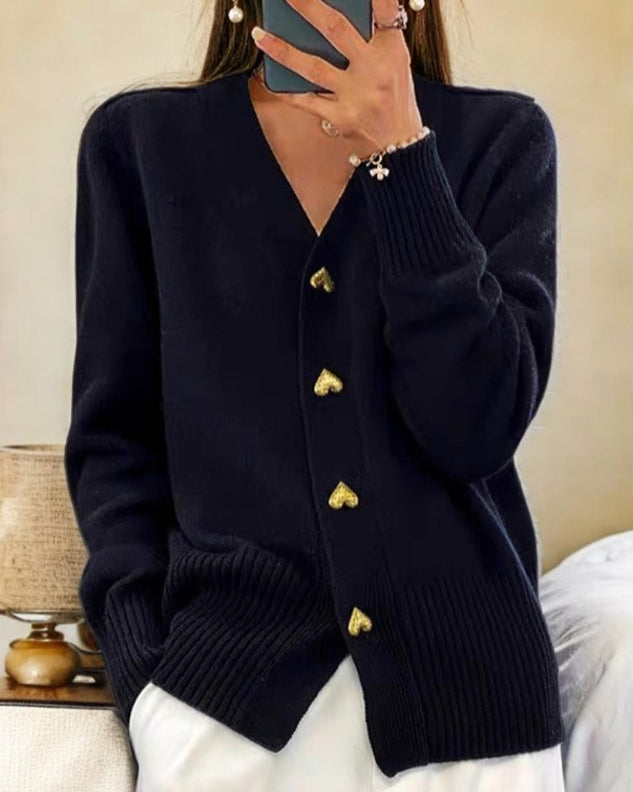 Chic women's sweater, a cozy long sleeve v-neck cardigan with romantic heart buttons. Ideal for stylish winter layering.