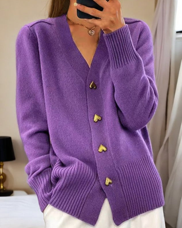 Cozy women's fashion sweater with romantic heart buttons. Elegant v-neck, long sleeve design. Ideal winter layer.