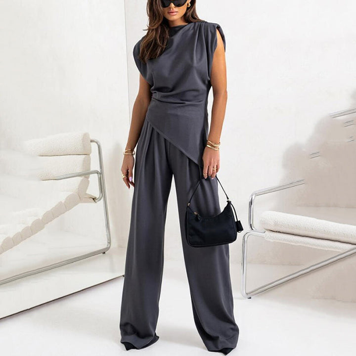 Fashionable women's matching outfit, a flowing draped top and comfortable wide-leg trousers. Casual wear.