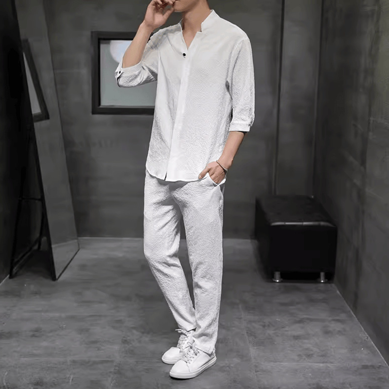 Casual men's linen blend two-piece set, perfect for summer. Features relaxed fit V-neck shirt & drawstring pants.