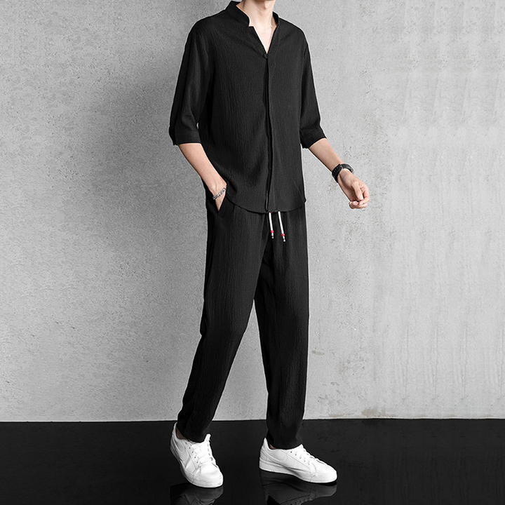 Comfortable men's relaxed fit linen blend two-piece set with V-neck shirt & drawstring pants, ideal for summer.