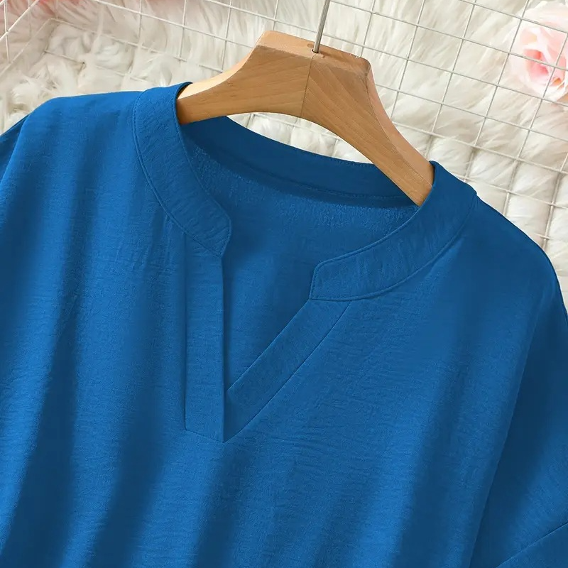 Women's elegant V-neck blouse with mid sleeves, a stylish and versatile top for spring/summer fashion.