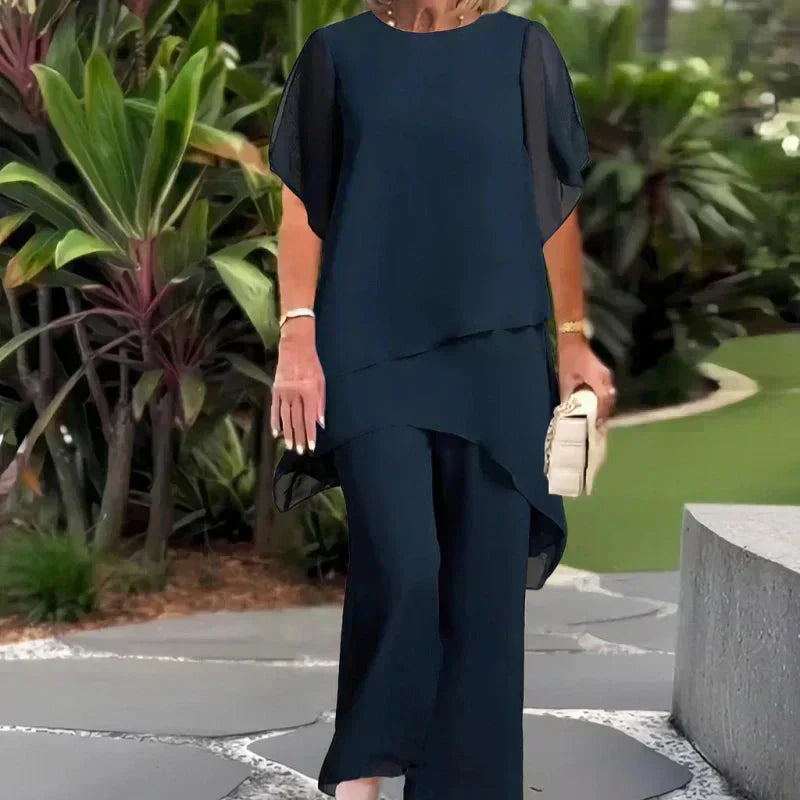 Chic women's two-piece relaxed ensemble with elegant wide-leg pants & layered top. Comfortable fashion set.