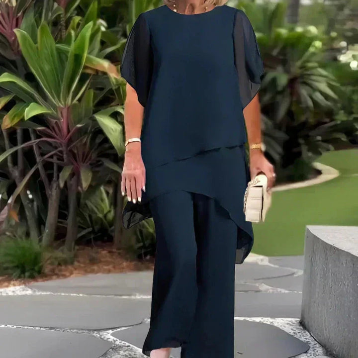 Chic women's two-piece relaxed ensemble with elegant wide-leg pants & layered top. Comfortable fashion set.