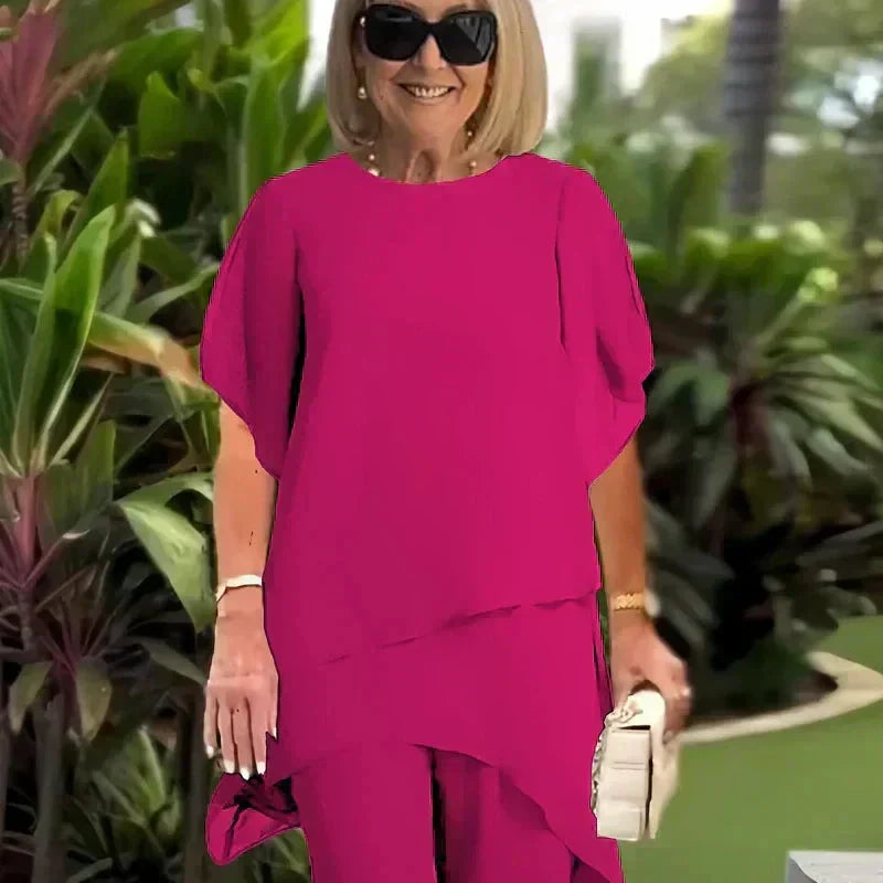 Relaxed women's two-piece outfit; chic wide-leg pants & elegant layered top. Comfortable fashion ensemble set.