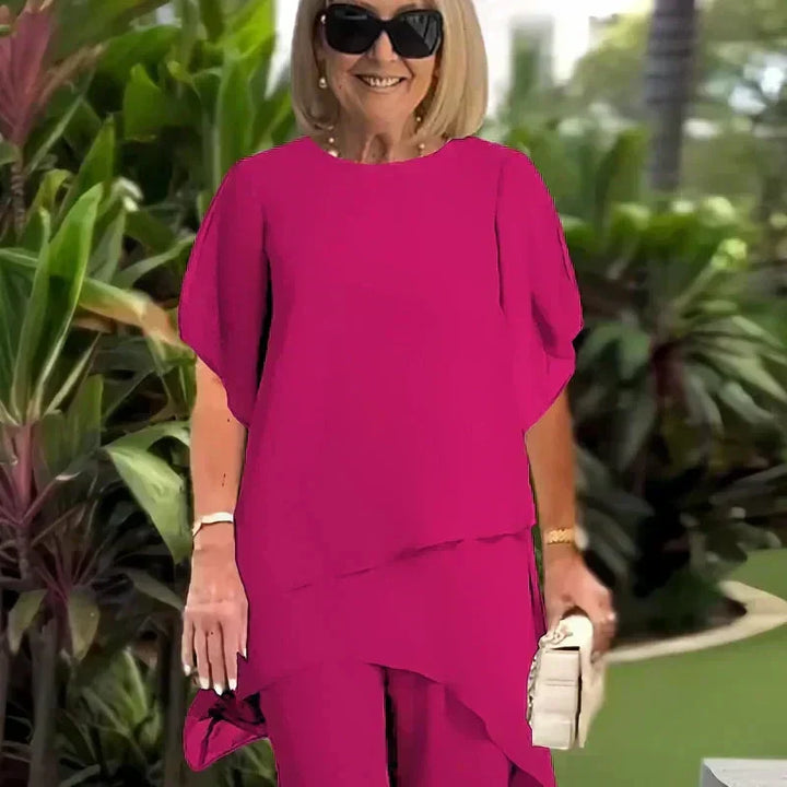 Relaxed women's two-piece outfit; chic wide-leg pants & elegant layered top. Comfortable fashion ensemble set.