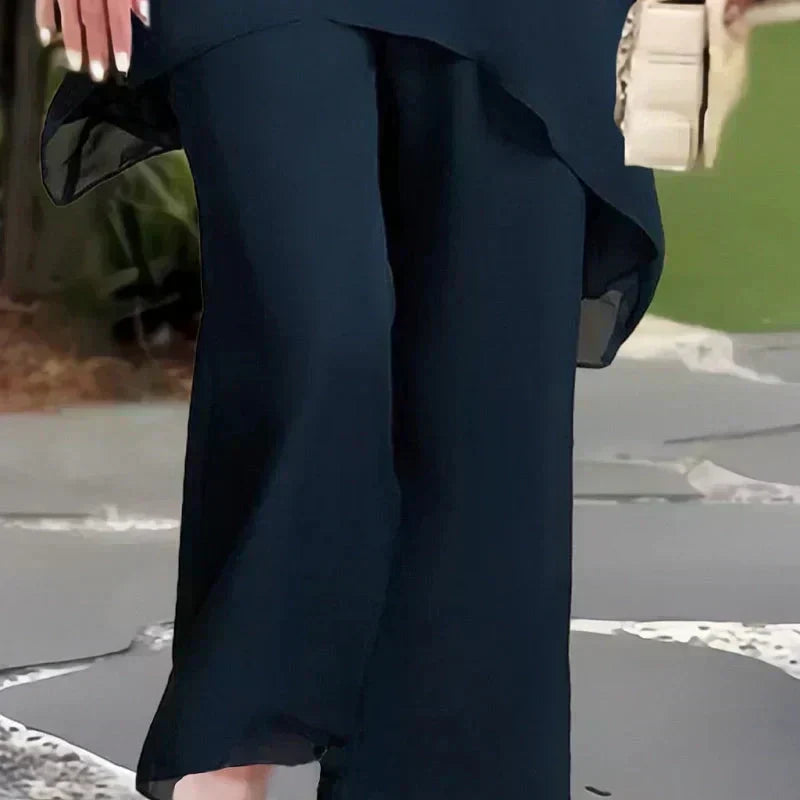 Woman wearing a chic relaxed two-piece set, featuring a stylish layered top and comfortable wide-leg pants.
