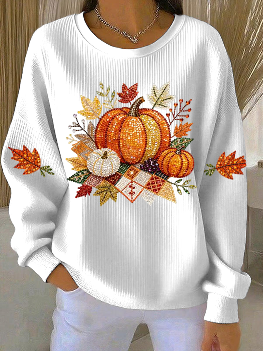 Cozy women's relaxed fit long-sleeve sweatshirt with a vibrant pumpkin graphic, perfect for autumn fashion.