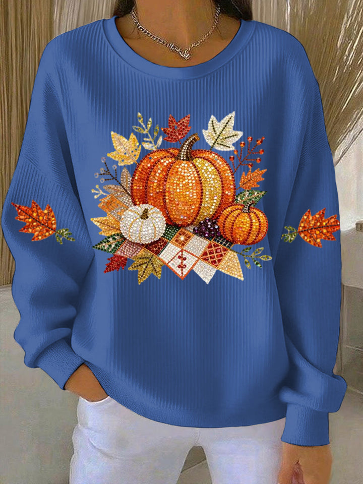 Close-up of the detailed pumpkin graphic on a women's relaxed fit autumn sweatshirt, highlighting festive design.
