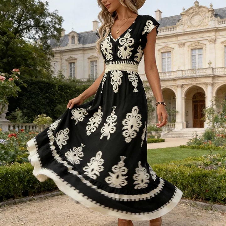 Black elegant women's midi dress with delicate embroidery, V-neck, and flared hem for summer occasions.